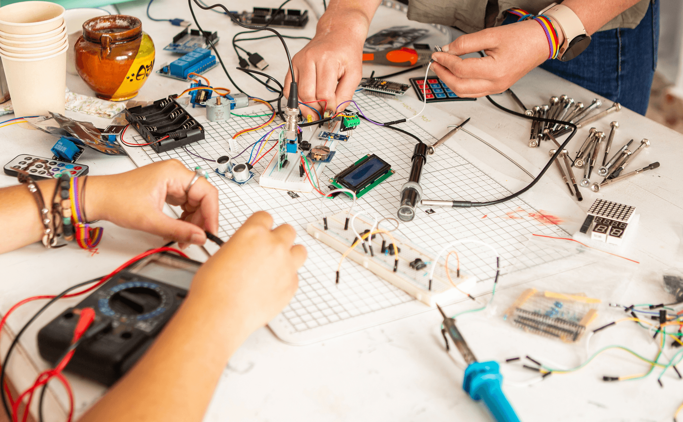closeup of work table with electronics and other interactive equipment